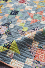Load image into Gallery viewer, This modern quilt pattern includes 8 sizes and step-by-step instructions for strip piecing and no-waste HSTs. Try Irish Vortex!