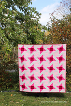 Load image into Gallery viewer, Want an easy star quilt with a twist? Irish Vortex uses strip piecing and HSTs to create a dynamic design with Irish chain roots.