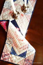 Load image into Gallery viewer, Add bold style to your table with this modern Aztec table runner! Made with 10 fabrics from the Sonata collection, it features both hand quilting and machine quilting for extra texture and detail. A perfect mini project for showing off your favorite prints!