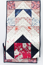 Load image into Gallery viewer, Show off your hand quilting skills with this 10-colour Modern Aztec table runner! Featuring fabrics from the Sonata collection, this piece blends bold geometric design with texture-rich stitching—perfect for centerpieces or seasonal decor updates.