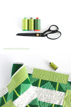 Load image into Gallery viewer, Green ombre large Aurifil thread spools with black tailor&#39;s shears and the Green ombre  Shattered Star quilted table runner | modern quilt pattern by Shannon Fraser Designs #quilting