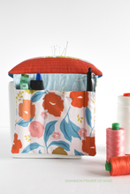 Load image into Gallery viewer, 📌 This scrap-friendly pincushion pattern is the perfect weekend project. Includes a handy hanging sleeve for your sewing station! #QuiltedPincushion #SewingRoomInspo