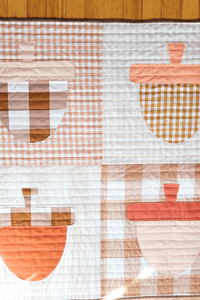This beginner-friendly appliqué quilt pattern combines elegance with playfulness. Create Cake Stands or Acorns—all in one pattern!