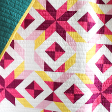 Load image into Gallery viewer, Colorful quilt with geometric pattern on a white background