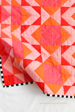 Load image into Gallery viewer, Celebrate color with this radiant Ode to Coral quilt version! Featuring a bold ombré gradient from orange to pink, this 10-colour Modern Aztec quilt brings warmth and joy to any room. Perfect for fabric lovers who enjoy vibrant palettes and modern design.