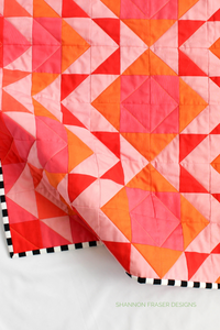 Celebrate color with this radiant Ode to Coral quilt version! Featuring a bold ombré gradient from orange to pink, this 10-colour Modern Aztec quilt brings warmth and joy to any room. Perfect for fabric lovers who enjoy vibrant palettes and modern design.