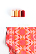 Load image into Gallery viewer, This Ode to Coral version of the Modern Aztec quilt features a fiery mix of coral, orange, and pink fabrics, arranged for a glowing ombré effect. A high-impact, color-forward quilt that’s perfect for confident beginners or anyone who loves modern flair!
