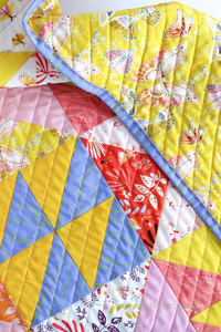 Quilt texture on the baby Pink Lemonade quilt featuring Aerial paired with Ruby and Bee solids. Grab your favorite FQ bundle and dive into a fun quilt adventure #babyquilt