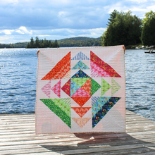 Load image into Gallery viewer, Colorful quilt with geometric pattern on a wooden dock by a lake