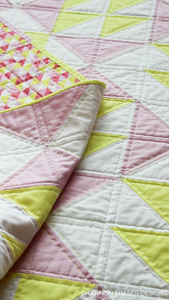 Modern and sweet baby girl quilt using the Pink Lemonade quilt pattern. Personalize your nursery décor with the beginner friendly quilt pattern.