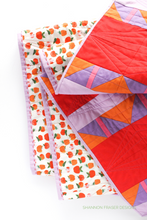 Load image into Gallery viewer, Big stitch binding detail plus the apples print by Heather Ross on the back of the Shattered Star quilt featuring Ruby &amp; Bee solids in red, purple, orange, pink and lilac. Shannon Fraser Designs #modernquilt