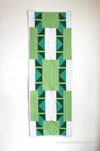 Load image into Gallery viewer, Shattered Star table runner pattern available in 3 sizes, shown here in medium featuring green ombré Artisan Cotton solids by Shannon Fraser Designs #quilt