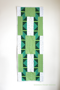 Shattered Star table runner pattern available in 3 sizes, shown here in medium featuring green ombré Artisan Cotton solids by Shannon Fraser Designs #quilt